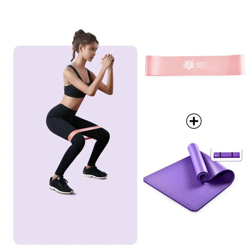 Thick non-slip yoga mat set with exercise band and woman practicing yoga poses.