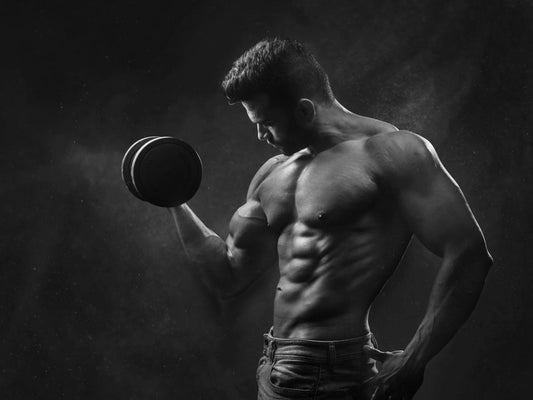 Muscular man lifting dumbbell in gym showcasing strength and fitness motivation