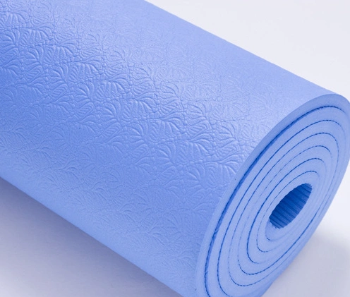 Eva Yoga™ Non Slip Yoga Mat in purple, rolled up, showcasing textured surface for superior grip and cushioning.