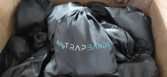 Box of Strap Bands Fitness Rally resistance bands in black drawstring bags.