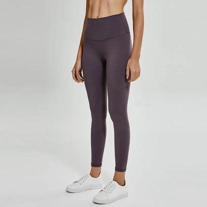 Female wearing fitness yoga cropped trousers in plain cotton blend, suitable for running and fitness activities.