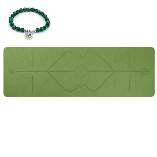 Eco-friendly green yoga mat with position line and bracelet, ideal for beginners.