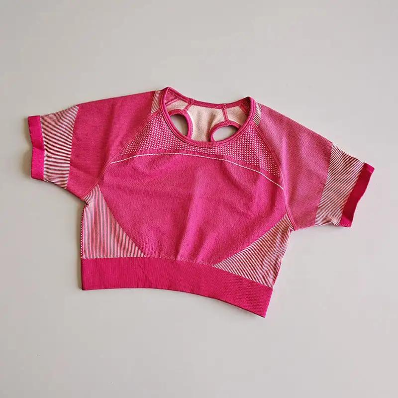 Pink fitness yoga top with round collar, designed for maximum comfort and flexibility, made from moisture-wicking nylon fabric.