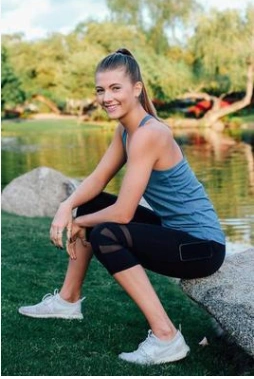 Yoga Fitness Pants worn by a person sitting outdoors by a scenic lake.