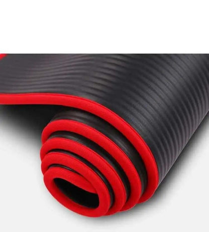 Black and red 10mm thick yoga mat rolled up.