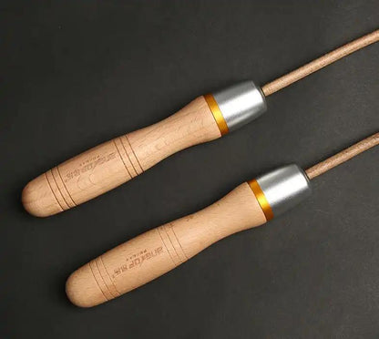 Adjustable fitness training skipping rope with cowhide material and wooden handles.