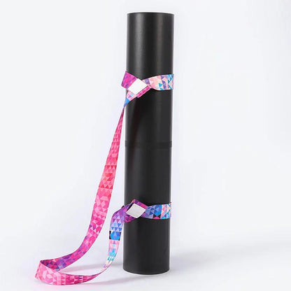 Colorful pure cotton yoga mat strap with gradient design, wrapped around a black yoga mat.