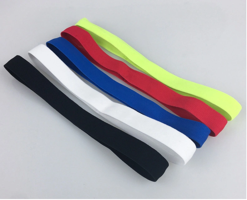 Various colored fitness yoga hair bands including black, white, red, blue, and fluorescent green displayed on a surface.