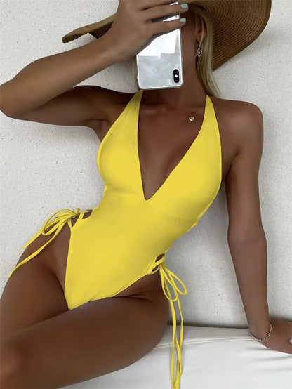 Yellow deep V lace-up one-piece swimsuit for women with a trendy design, ideal for beach or pool parties.