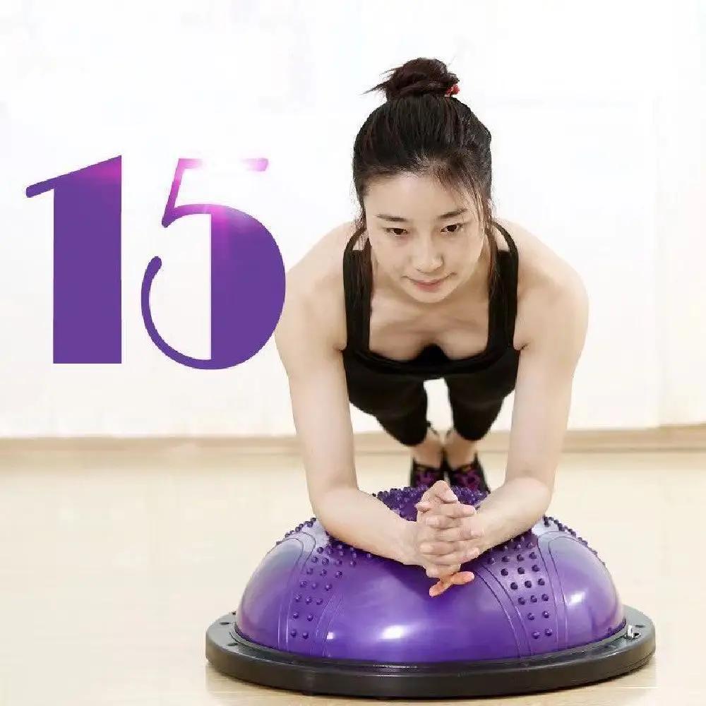 woman doing plank on purple pilates ball