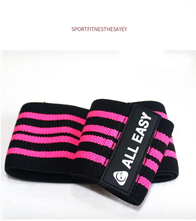 Yoga fitness training elastic band tension band in pink and black design.