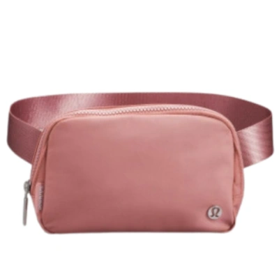 Crossbody backpack in cherry pink, nylon material, zipper closure.