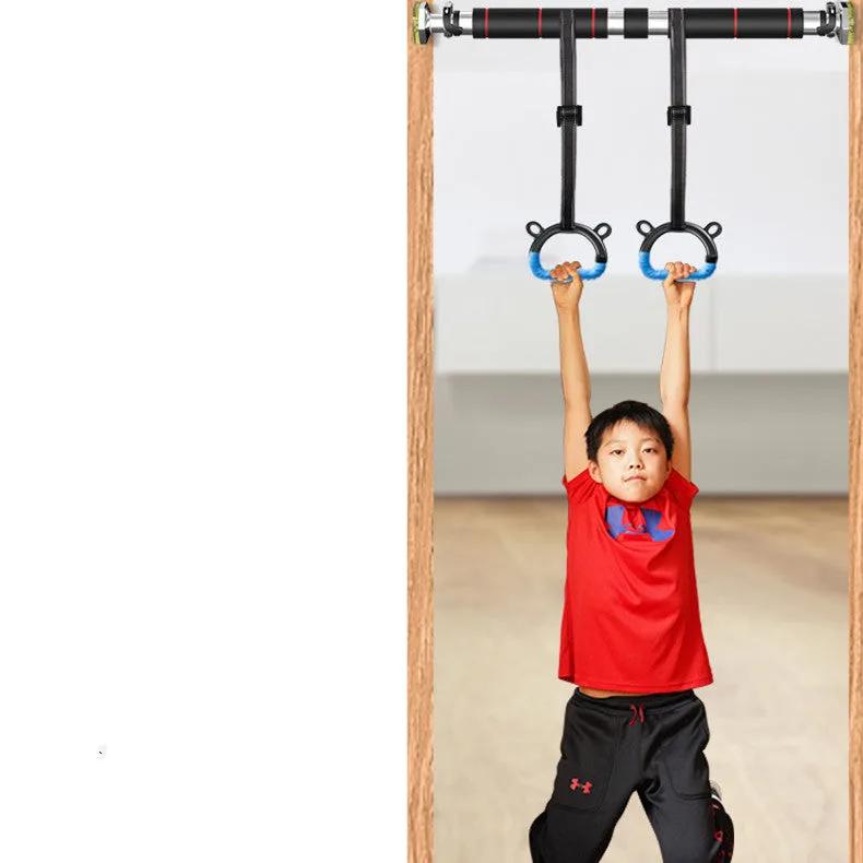 Child using home fitness rings for exercise indoors.