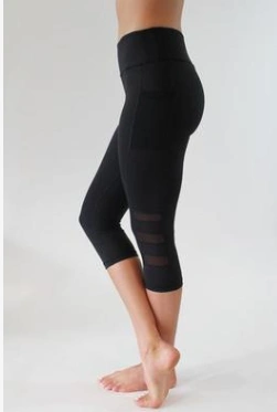 Black yoga fitness pants with mesh detailing on legs.