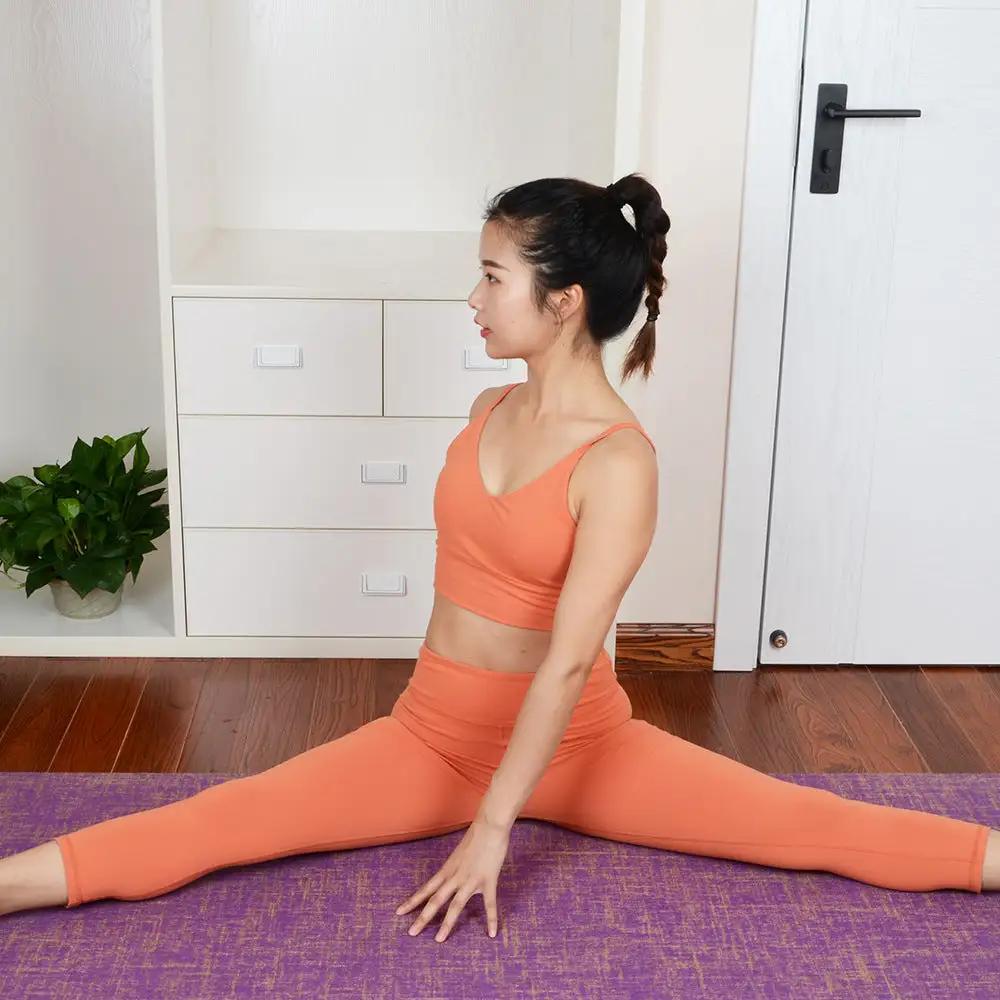 Woman practicing yoga on purple anti-slip sports yoga mat indoors