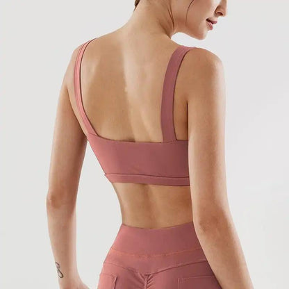 Woman wearing pink fitness yoga underwear, back view.