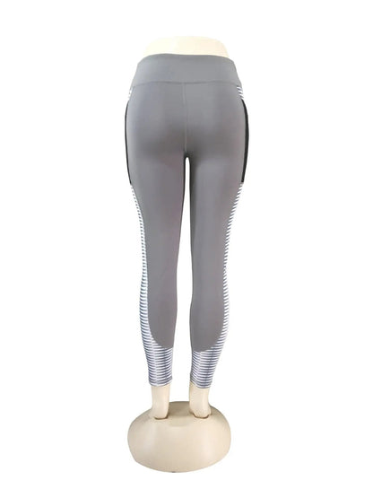 Gray yoga running fitness pants with stripe detailing on legs, made of a hemp blend and nylon, available in sizes S to XL.