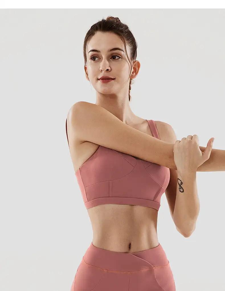 Women's fitness yoga underwear set made of nylon, featuring a sleek, supportive sports bra and high-waist leggings in pink.