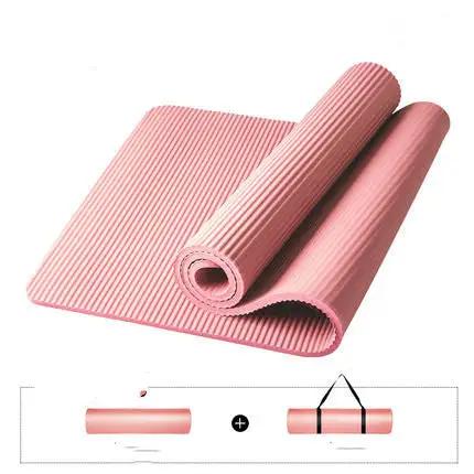 Pink yoga mat with anti-skid texture, rolled with storage straps.