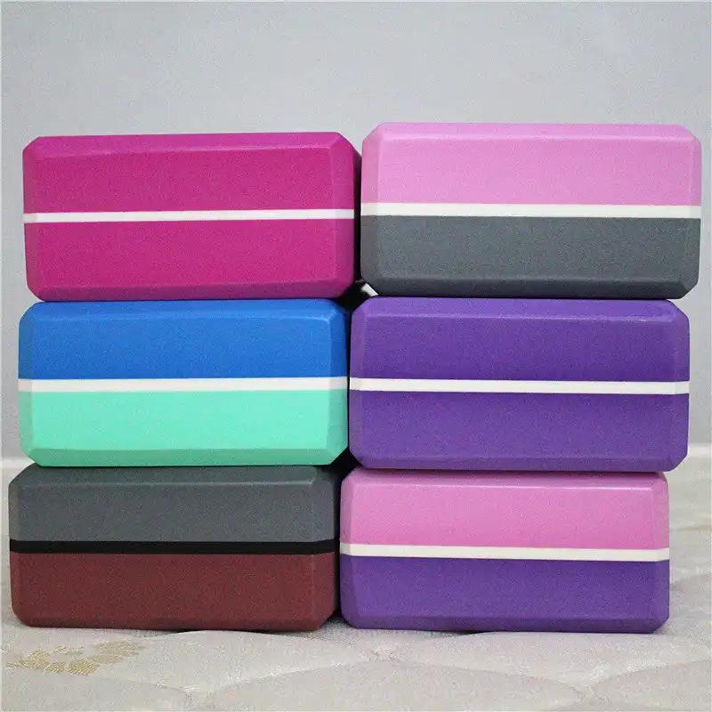 Two-color yoga bricks in various shades stacked in rows.