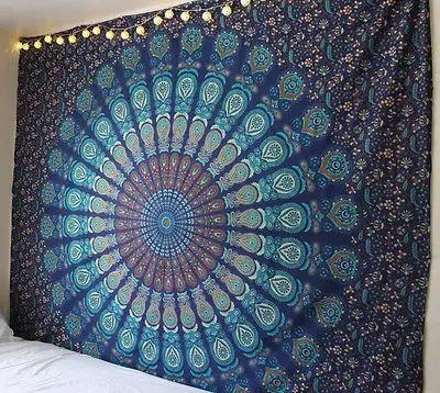 Blue mandala tapestry hanging on a wall in a bedroom.