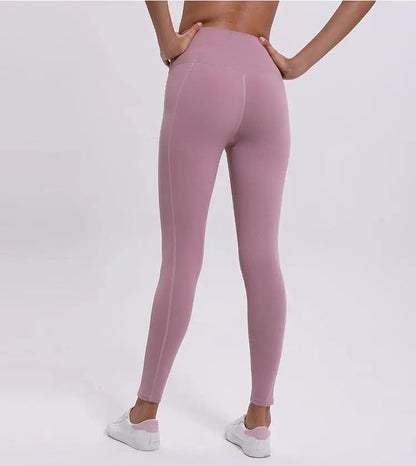 Female model wearing pink fitness yoga cropped trousers, ideal for running and sports activities.