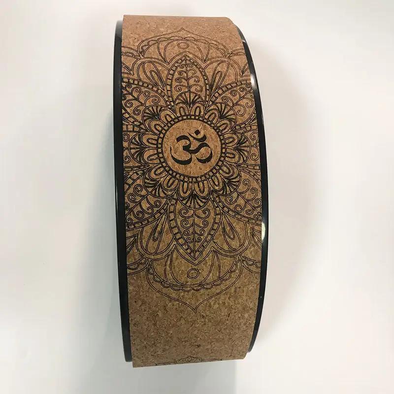 Cork yoga wheel with mandala design for backbend exercises.