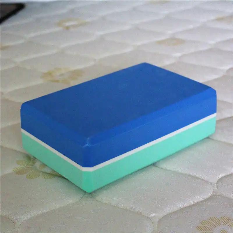 two-color yoga brick on mat, dual-colored design