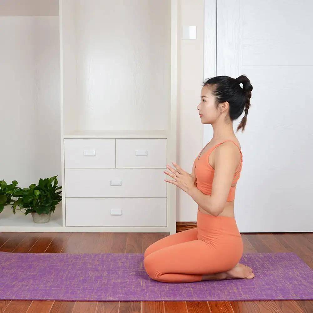 Woman practicing yoga on anti-slip sports yoga mat in home setting.