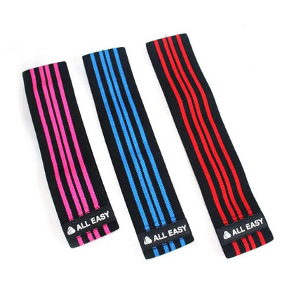 Yoga fitness training elastic tension bands in pink, blue, and red.