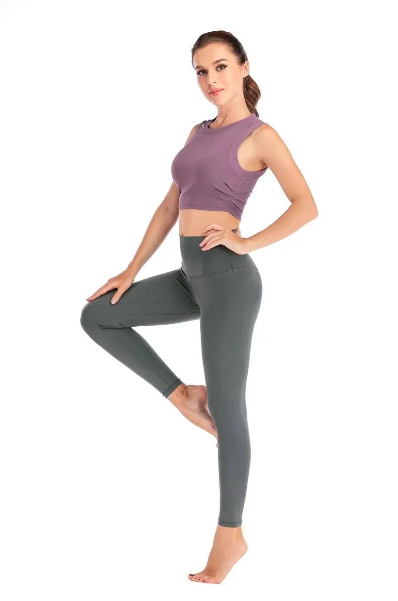 Female wearing fitness yoga vest in lotus pink, posed for sports activities.