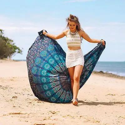 Yoga Mat with vibrant mandala design displayed on a beach.