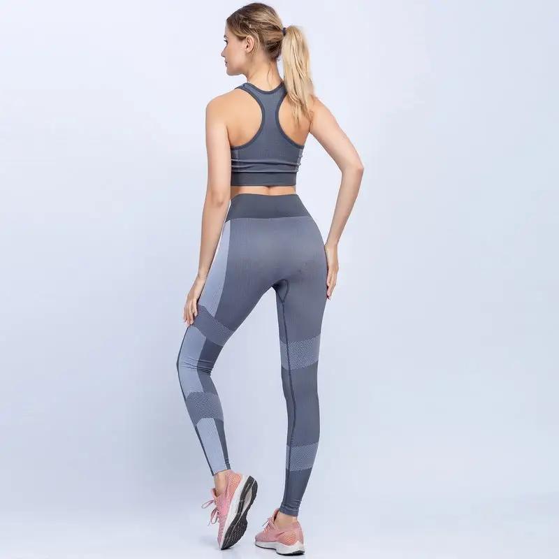 Women's seamless yoga set in grey, featuring a racerback top and high-waisted leggings, ideal for fitness activities.