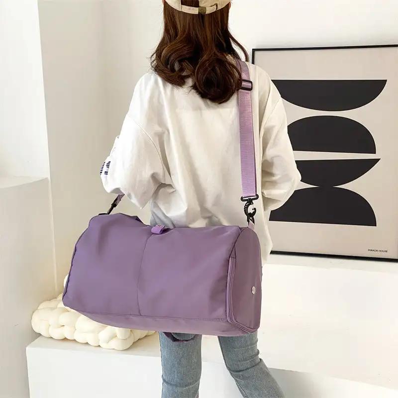 Women's yoga bag with wet separation, large capacity storage, purple shoulder and crossbody style, displayed on a model.